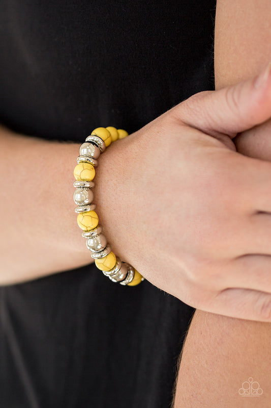 Paparazzi Accessories Across the Mesa - Yellow Bracelets a collection of silver accents and sunny yellow stones are threaded along a stretchy band for a seasonal look. Sold as one individual bracelet.