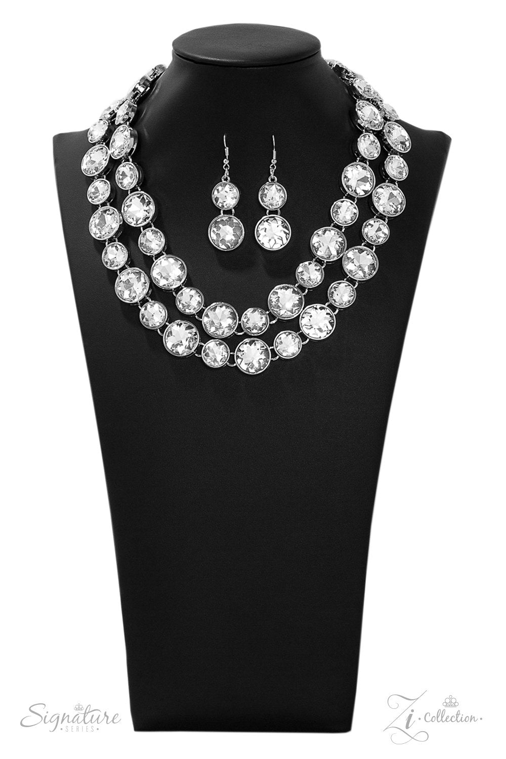 Paparazzi Accessories The Natasha - 2019 Zi Collection Necklace two rows of dramatically oversized rhinestones sparkle blindingly along the collar. The alternating sizes of the gems give this showstopper some exaggerated depth and dazzle. Features an adjustable clasp closure. Named after 2019 Rock the Runway winner, Natasha C. Sold as one individual necklace. Includes one pair of matching earrings.