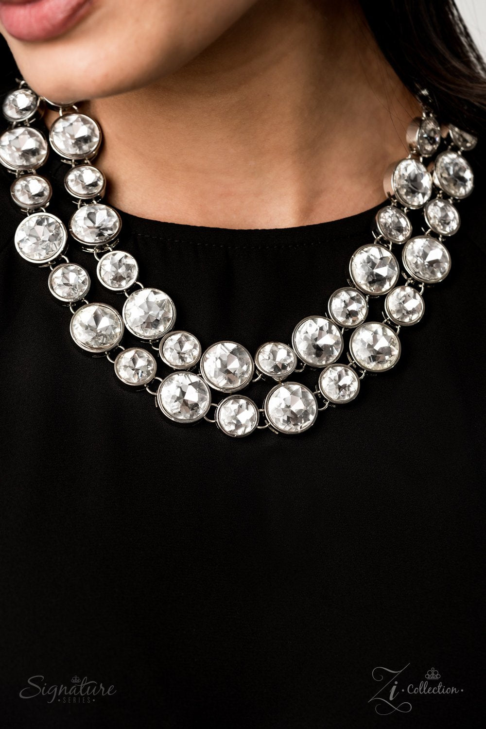 Paparazzi Accessories The Natasha - 2019 Zi Collection Necklace two rows of dramatically oversized rhinestones sparkle blindingly along the collar. The alternating sizes of the gems give this showstopper some exaggerated depth and dazzle. Features an adjustable clasp closure. Named after 2019 Rock the Runway winner, Natasha C. Sold as one individual necklace. Includes one pair of matching earrings.