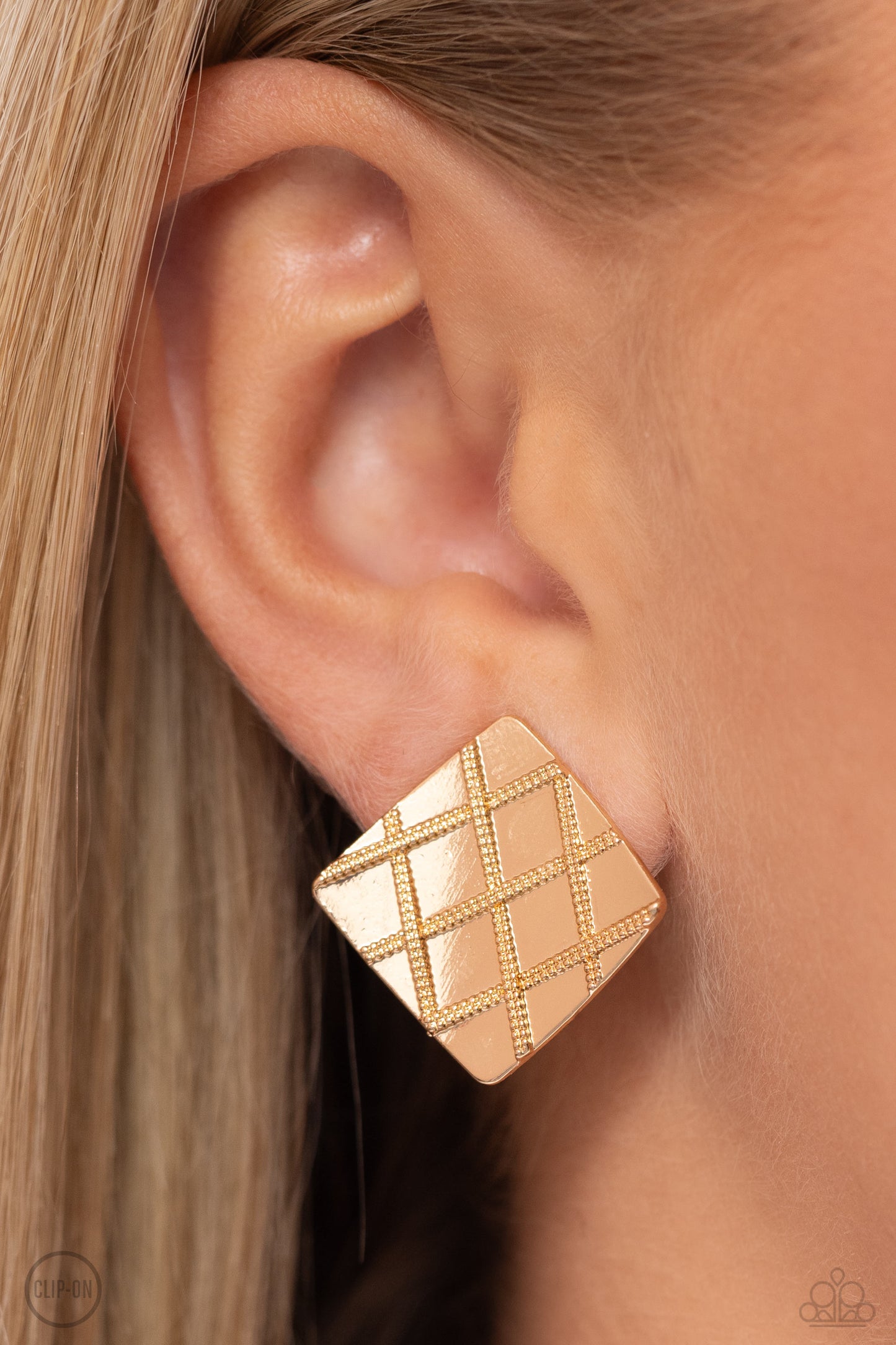 Paparazzi Accessories - Plaid and Simple - Gold Clip-On Earrings a curving gold square is embossed in a slanted plaid-like pattern, creating a tactile frame. Earring attaches to a standard clip-on fitting.  Sold as one pair of clip-on earrings.