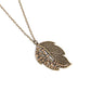 Paparazzi Accessories - A Mid-AUTUMN Nights Dream - Brass Necklaces a half of a lifelike brass leaf frame is adorned in glittering topaz rhinestones as it hangs from the bottom of a lengthened brass chain, creating a simple seasonal sparkle. Features an adjustable clasp closure.  Sold as one individual necklace. Includes one pair of matching earrings.