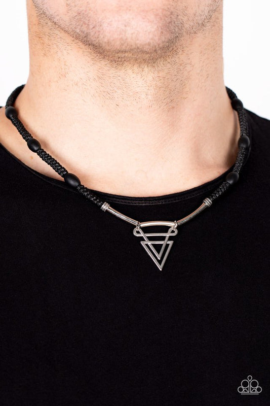 Black wooden beads are knotted in place along a braided black cord below the collar. Infused with silver rod-like beads, an ornately stacked silver triangular pendant swings from the center for a sharp finish. Features a button loop closure.  Sold as one individual necklace.