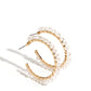 Paparazzi Accessories - Halo Hustle - Gold Hoop Earrings threaded along a dainty gold wire, an iridescent collection of glassy white crystal-like beads wrap around the front of a classic gold hoop for an unexpected pop of shimmer. Hoop measures approximately 1 3/4" in diameter.  Sold as one pair of hoop earrings.