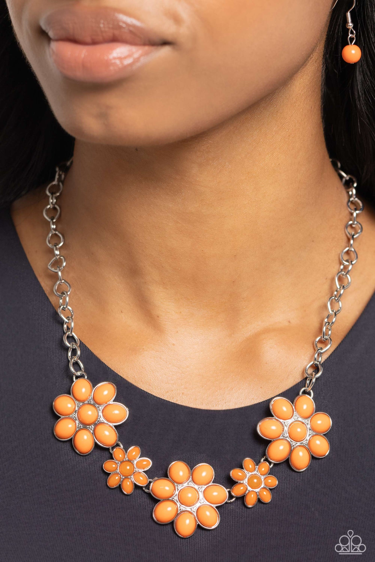 Paparazzi Accessories - Flamboyantly Flowering - Orange Necklaces flirtatious collection of orange dotted floral frames alternate with dainty opaque orange flowers below the collar, creating a vivacious pop of color. Features an adjustable clasp closure.  Sold as one individual necklace. Includes one pair of matching earrings.