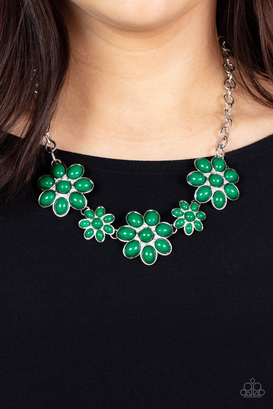 Paparazzi Accessories - Flamboyantly Flowering - Green Necklaces flirtatious collection of Leprechaun dotted floral frames alternate with dainty opaque Leprechaun flowers below the collar, creating a verdant pop of color. Features an adjustable clasp closure.  Sold as one individual necklace. Includes one pair of matching earrings.