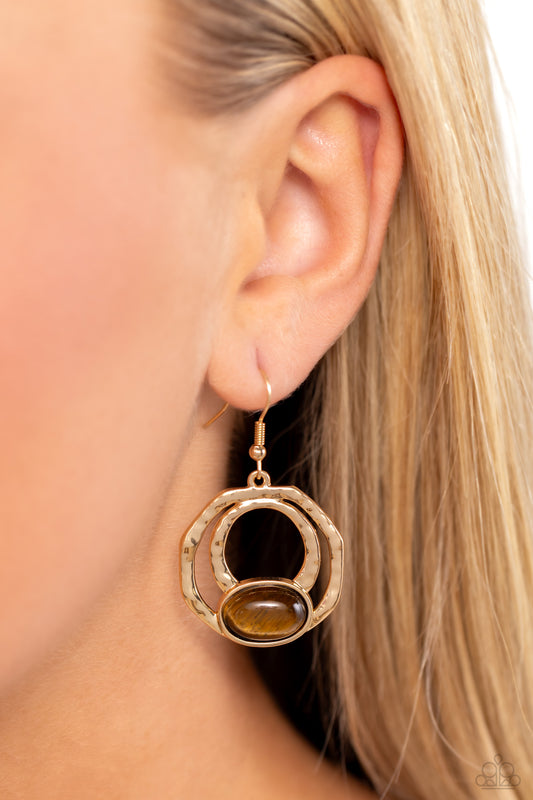 Paparazzi Accessories - Terestrial Retreat - Brown Earrings an oval tiger's eye stone is pressed into the bottom of a layered geometric gold frame radiating with hammered texture, resulting in an earthy and edgy trinket. Earring attaches to a standard fishhook fitting.
