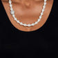 Paparazzi Accessories - Countess Chic - White Pearl Necklace strung along the entirety of an invisible wire, classic white pearls in varying sizes coalesce down the neckline for a refined finish. Adding to the elegant design, a sparkly white rhinestone-encrusted silver ornament shimmers amongst the sea of pearls. Features an adjustable clasp closure.  Sold as one individual necklace. Includes one pair of matching earrings.