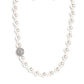 Paparazzi Accessories - Countess Chic - White Pearl Necklace strung along the entirety of an invisible wire, classic white pearls in varying sizes coalesce down the neckline for a refined finish. Adding to the elegant design, a sparkly white rhinestone-encrusted silver ornament shimmers amongst the sea of pearls. Features an adjustable clasp closure.  Sold as one individual necklace. Includes one pair of matching earrings.