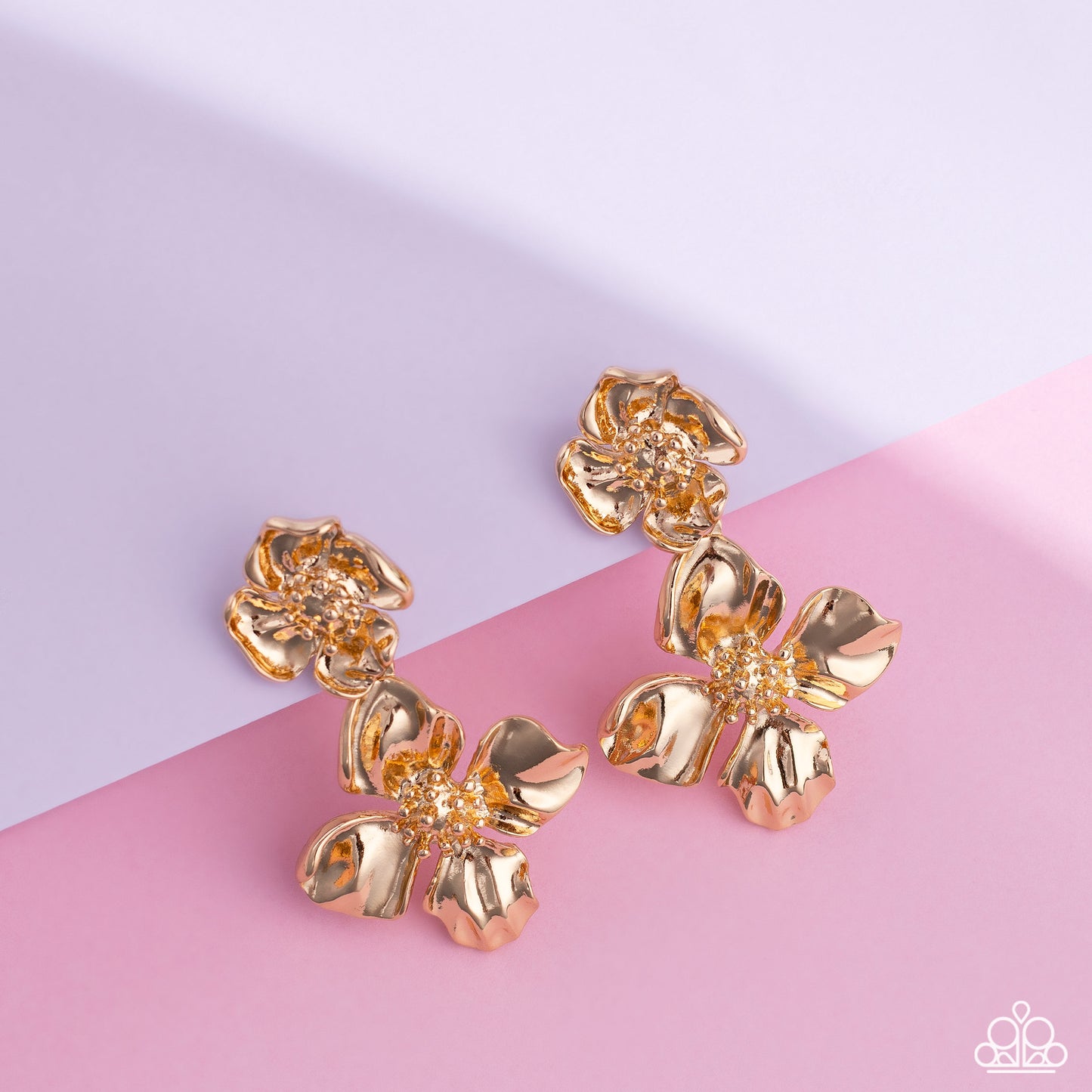 Paparazzi Accessories - Gilded Grace - Gold Earrings featuring a warped metallic texture, an oversized gold flower hangs from a smaller gold flower for a whimsical finish. Dainty gold studs coalesce the centers of each flower, adding tactile detail to the floral design. Earring attaches to a standard post fitting. Sold as one pair of post earrings.