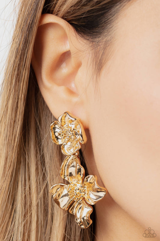 Paparazzi Accessories - Gilded Grace - Gold Earrings featuring a warped metallic texture, an oversized gold flower hangs from a smaller gold flower for a whimsical finish. Dainty gold studs coalesce the centers of each flower, adding tactile detail to the floral design. Earring attaches to a standard post fitting. Sold as one pair of post earrings.