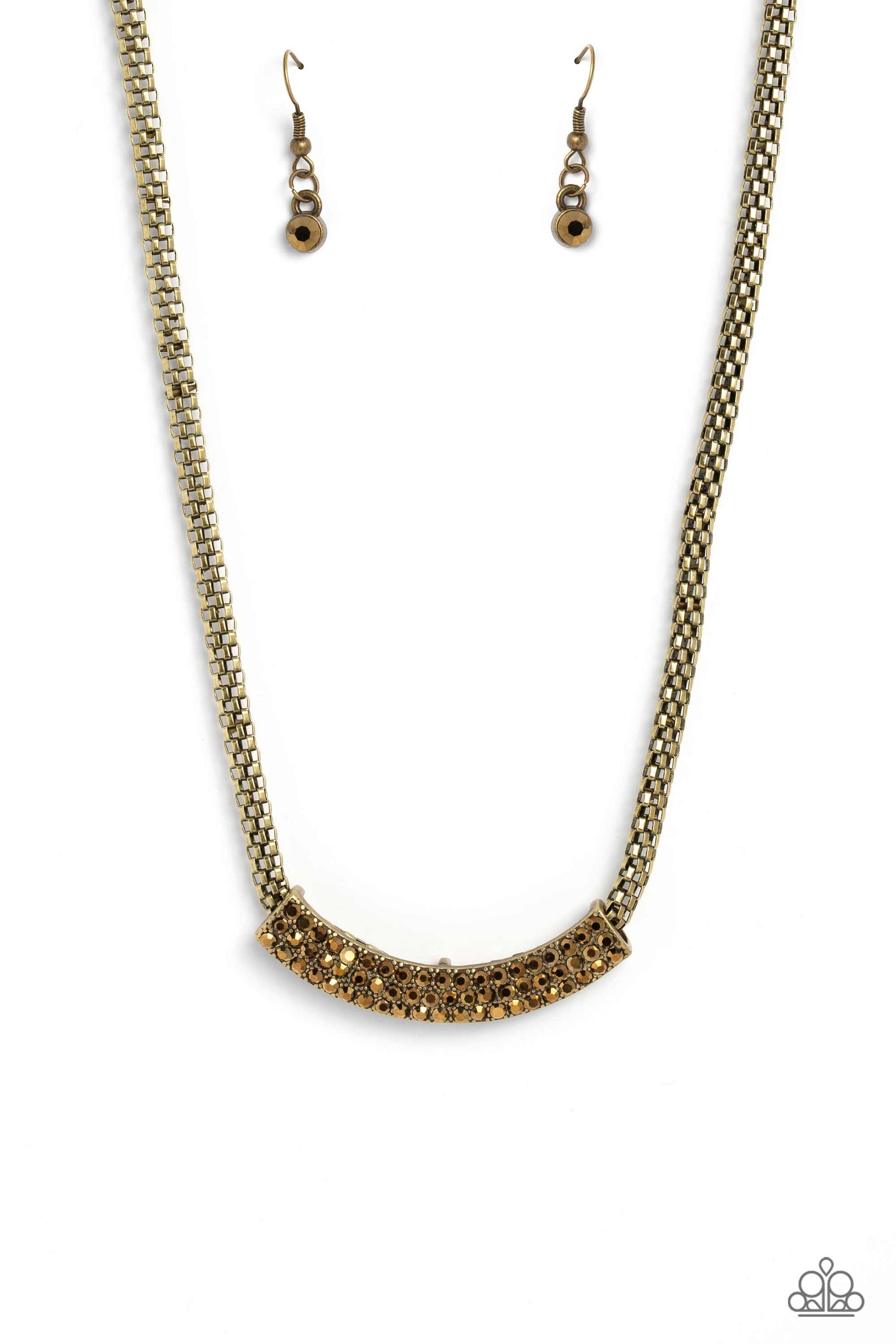 Paparazzi Accessories - Swing Dance Dream - Brass Necklaces featuring a gritty finish, a curved brass pendant slides along a rounded brass mesh chain below the collar. Three rows of dainty aurum rhinestones encrusted along the brass frame, add hints of shimmer to the bold industrial palette. Features an adjustable clasp closure.  Sold as one individual necklace. Includes one pair of matching earrings.