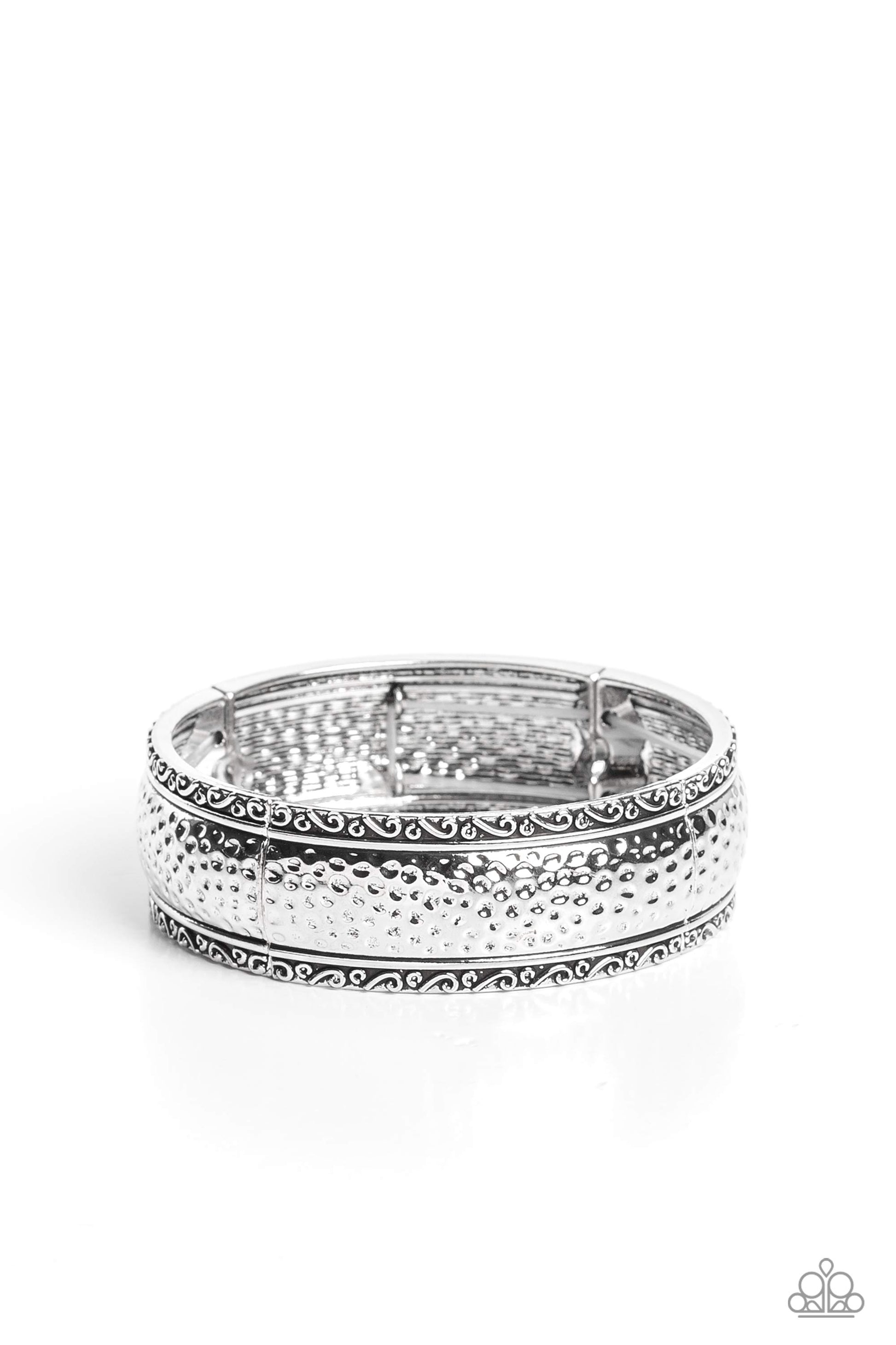 Paparazzi Accessories - Textile Tenor - Silver Bracelet curved frames of high-sheen silver curve around the wrist on elastic stretchy bands. Studs and ribbons of silver curl into a dainty filigree above and below its hammered center for a soft and dauntless combo.  Sold as one individual bracelet.