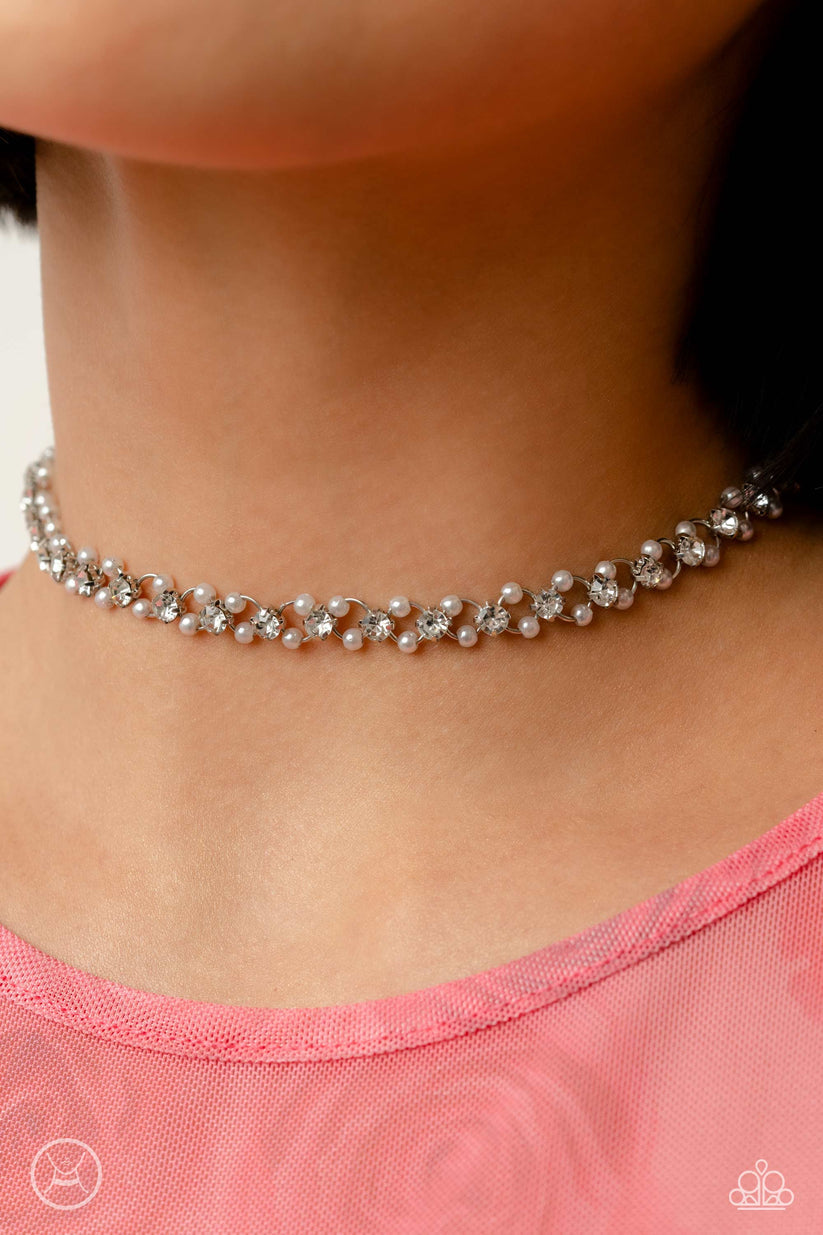 Delicately etched in subtle shimmer, a classic silver chain is infused with dainty white pearls and white-pronged gems for a dainty display of class that drapes across the collar. Features an adjustable clasp closure.  Sold as one individual choker necklace. Includes one pair of matching earrings.