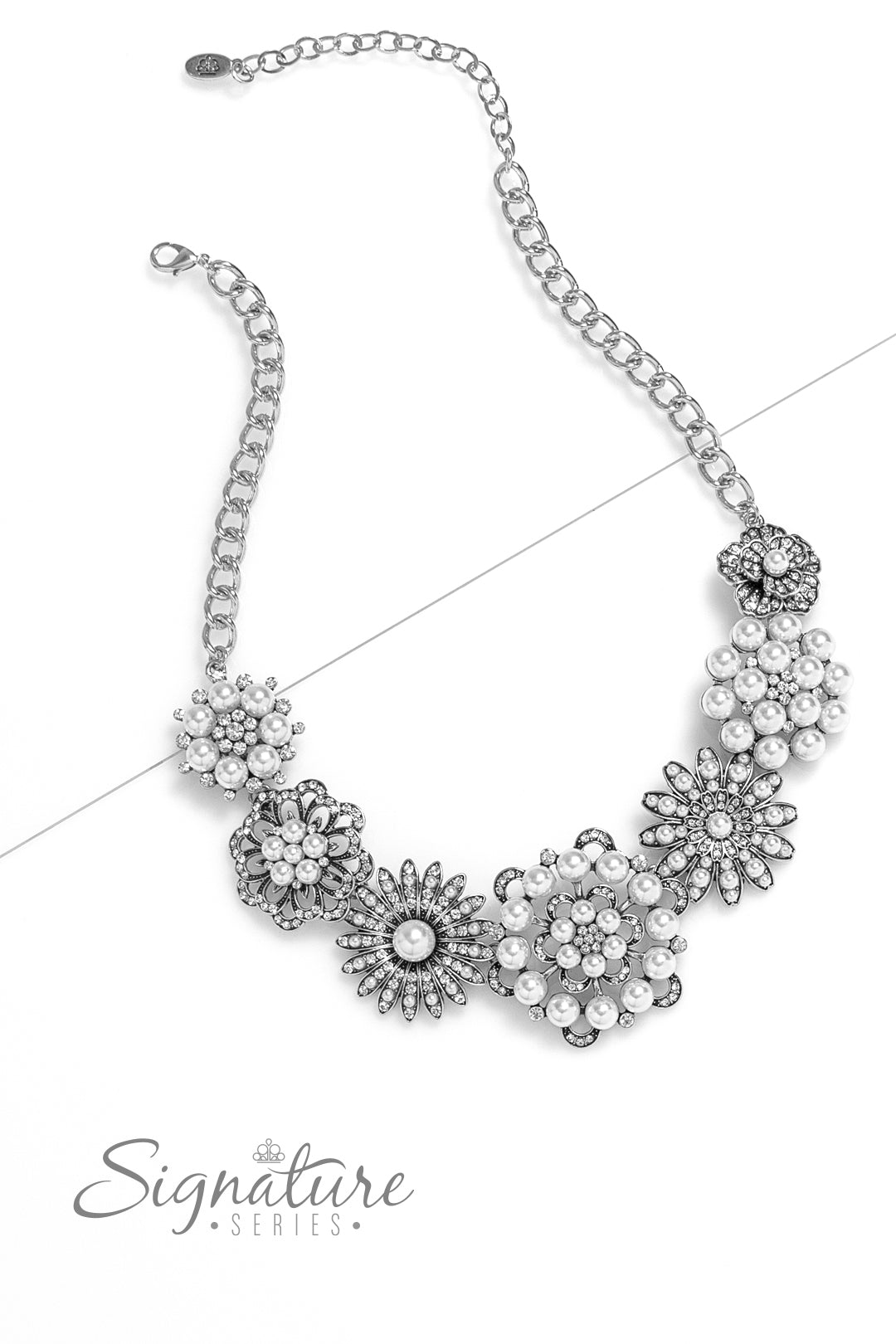 Polished white pearls and brilliant white rhinestones bloom atop a framework of silver, forming seven unique flowers adorned in dizzying detail. Each flower features a unique centerpiece encircled by silver petals lined with luminescence and intricate detail. The flourish of florals links whimsically along the neckline, resulting in an unforgettable statement piece that sparkles with sentiment. Features an adjustable clasp closure.  Sold as one individual necklace. Includes one pair of matching earrings.
