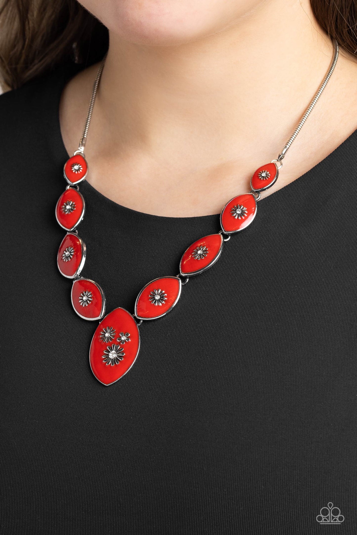 Paparazzi Accessories - Pressed Flowers - Red Necklaces featuring vibrant red paint, a collection of silver marquise-shaped frames gradually increase in size as they taper below the collar in a timeless fashion on a silver snake chain. Each frame is embossed with a delicate silver flower with a white rhinestone center, with the centermost pendant featuring three flowers, creating a glamorous array of whimsicality. Features an adjustable clasp closure. 