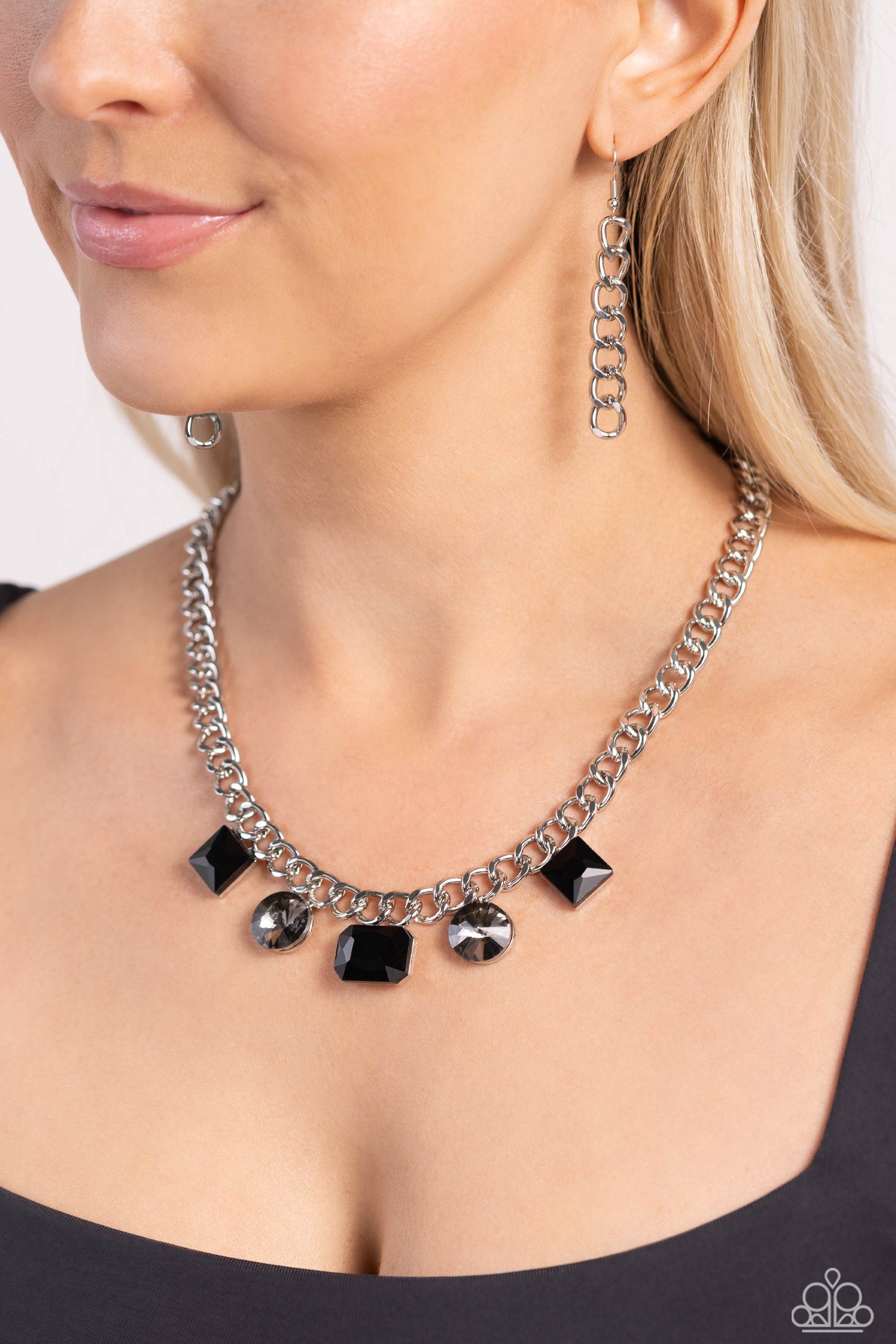 Paparazzi Accessories - Alternating Audacity - Black Necklaces featuring black and smoky finishes, a collection of geometric gems in sleek silver fittings adorns the center of a thick silver chain for a refined finish. Features an adjustable clasp closure.  Sold as one individual necklace. Includes one pair of matching earrings.