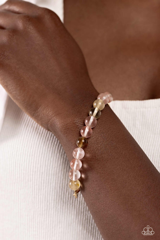 Paparazzi Accessories - Energetic Edge - Pink Bracelet a strand of gold paperclip chain collides with glassy pink stone beads in various hues along a stretchy band to create a seasonally urban statement. As the stone elements in this piece are natural, some color variation is normal.  Sold as one individual bracelet.