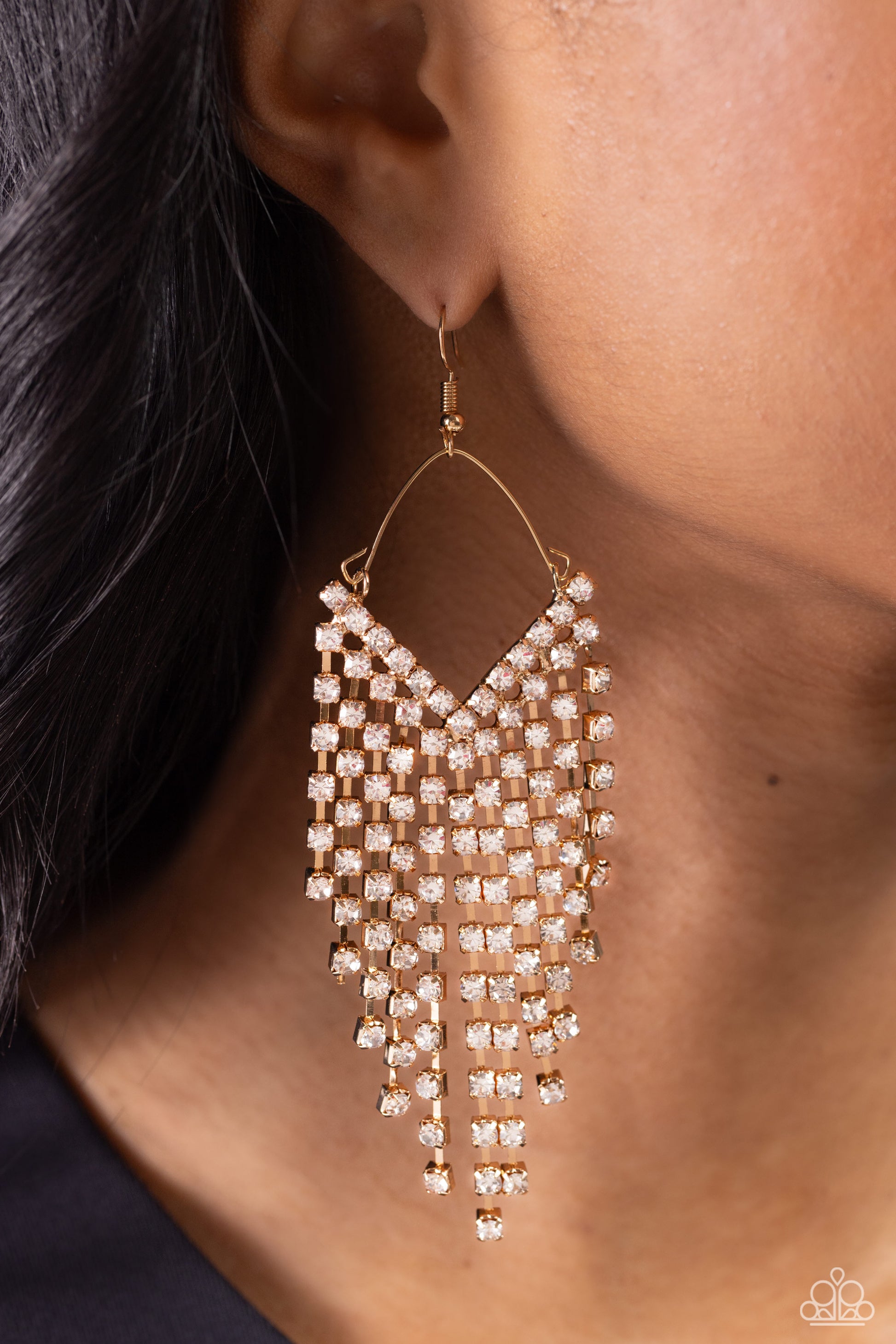 Paparazzi Accessories - V Fallin - Gold Earrings attached to a dainty gold wire fitting, strands of glittery white rhinestones pressed in sleek gold fittings freefall from the ear into an edgy v-shaped cascade for a bold look. Earring attaches to a standard fishhook fitting.  Sold as one pair of earrings.