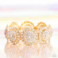 Paparazzi Accessories - Executive Elegance - Multi Bracelets featuring a wheel motif, concaved gold discs embossed in an explosion of iridescent rhinestones slide along a stretchy band around the wrist for a hint of dazzling refinement. Due to its prismatic palette, color may vary.  Sold as one individual bracelet.