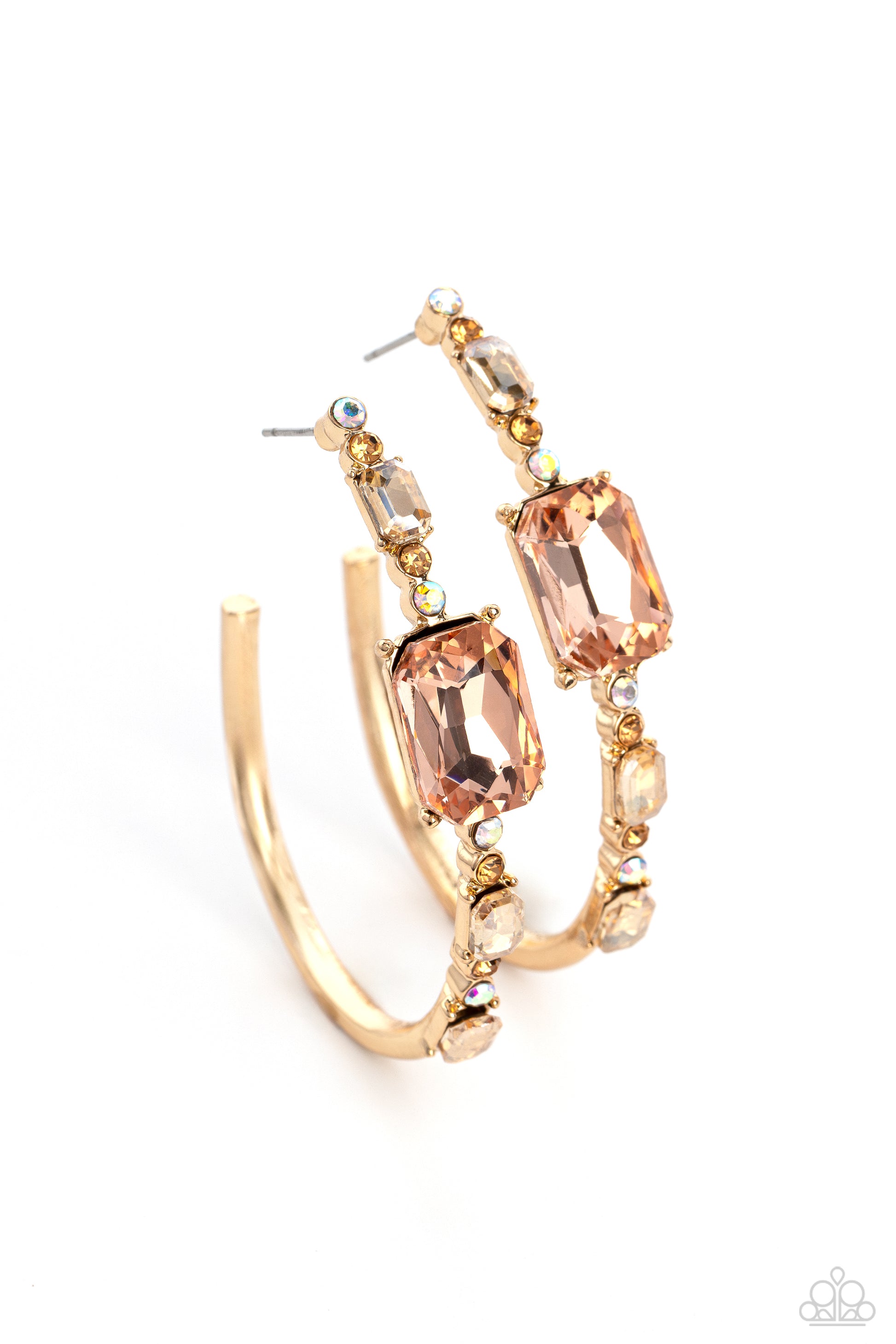 Paparazzi Accessories - Elite Ensemble - Gold Hoop Earrings encrusted in round and emerald-cut champagne, peach, iridescent and golden topaz gems, an exaggerated oblong gold hoop curls around the ear, refracting light in a dramatic, knockout finish. Earring attaches to a standard post fitting. Hoop measures approximately 2" long. Due to its prismatic palette, color may vary.  Sold as one pair of hoop earrings.