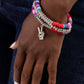 Paparazzi Accessories - Peaceful Potential - Red Bracelets infused along stretchy bands red, pink, green, and various shades of blue rubber discs combine with sporadically placed silver discs and a silver disc strand for a vibrant pop of color along the wrist. A silver peace sign dangles from one of the colorful strands for a youthful finish.  Sold as one set of three bracelets.