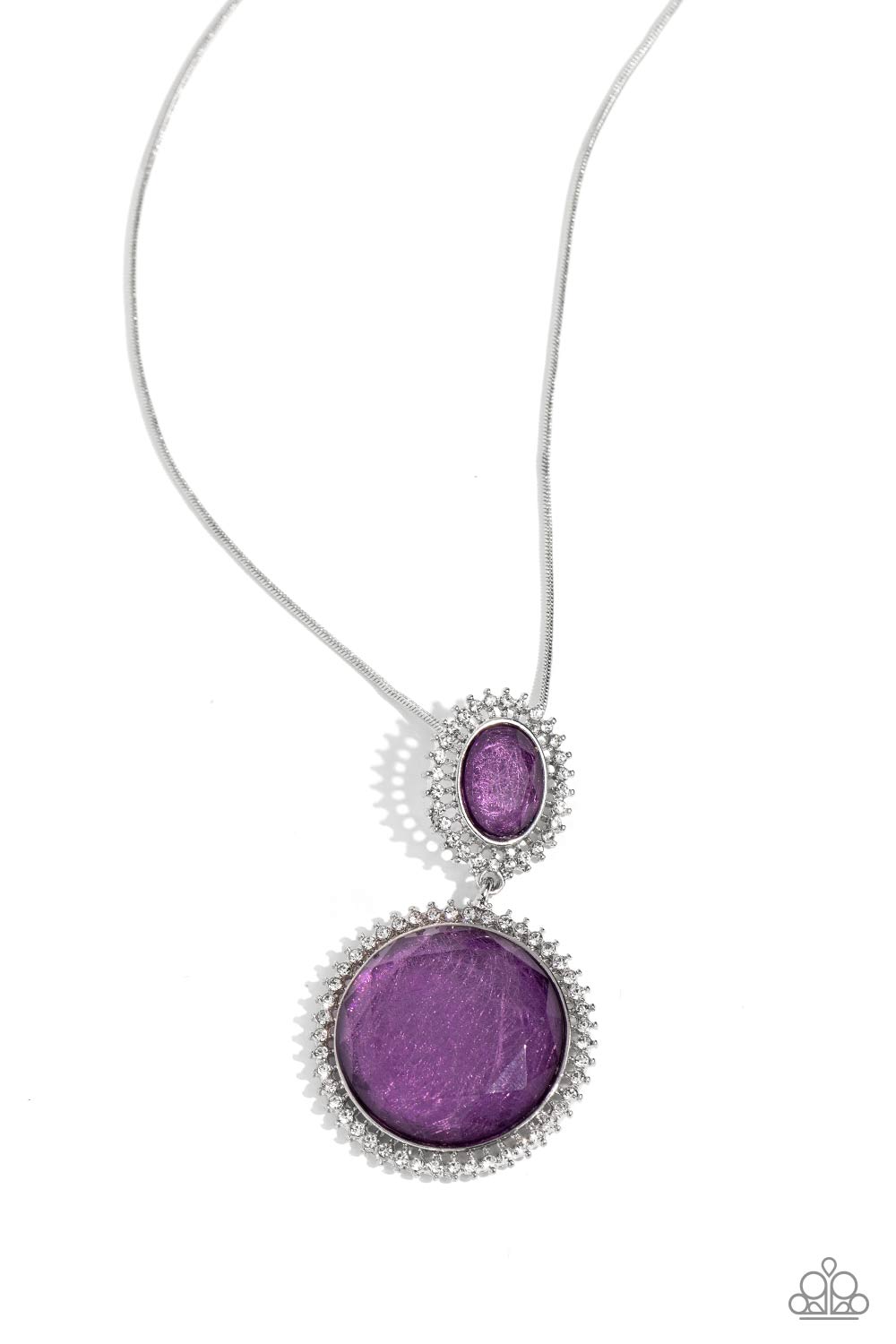 Paparazzi Accessories - Castle Cadenza - Purple Neckencasfeaturing a scratched motif, a large purple gem is encased in a border of rhinestone-dusted silver, as it's suspended from a smaller version of the same design but in an oval shape. The stacked pendant then slides along an elongated silver snake chain for a regal finish. Features an adjustable clasp closure.  Sold as one individual necklace. Includes one pair of matching earrings.