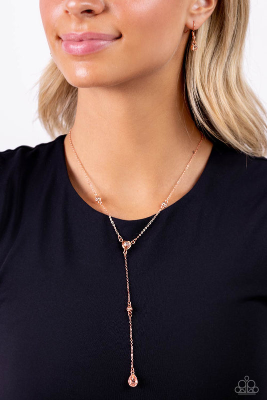 Paparazzi Accessories - Lavish Lariat - Copper Nedelicatedainty strands of glistening shiny copper chain delicately knot into a timeless tassel for a refined flair. Peachy gems in varying sizes and in round, teardrop, and heart applications are infused along the shiny copper chain in sleek shiny copper fittings for a touch of light-reflecting dazzle. Features an adjustable clasp closure.  Sold as one individual necklace. Includes one pair of matching earrings.
