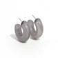 Paparazzi Accessories - Acrylic Acclaim - Silver Hoop Earrings featuring a milky accent, thick gray acrylic frames snugly loop and curl just below the ear for a fashionable finish. Earring attaches to a standard post fitting. Hoop measures approximately 1" in diameter.  Sold as one pair of hoop earrings.