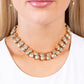 Paparazzi Accessories - Glistening Galary - Gold Choker Necklaces featuring pronged gold fittings, strands of oversized, glittery white rhinestones connect with rows of gold box chains around the neck for a glittery twist. Features an adjustable clasp closure.  Sold as one individual choker necklace. Includes one pair of matching earrings.