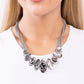 Paparazzi Accessories - Sliding Splendor - Silver Necklaovalfeaturing a lightly hammered sheen, asymmetrical silver ovals, some with airy silhouettes and exaggerated smoky gem centers, give off a hand-made feel as they shift and slide through multiple strands of gray cording for an artisanal design below the collar. Features an adjustable clasp closure.  Sold as one individual necklace. Includes one pair of matching earrings.