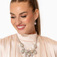 Paparazzi Accessories - Dripping in Dazzle - December 2023 Life of the Party Multi Necklaces an explosion of round, teardrop, and marquise-cut gems in varying sizes bordered by tactile silver studs cluster together to create a glittery iridescent showcase down the neckline. Featuring various shades of iridescence, each gem reflects light off of its faceted surface emitting further glitz and glam. Features an adjustable clasp closure. Due to its prismatic palette, color may vary.