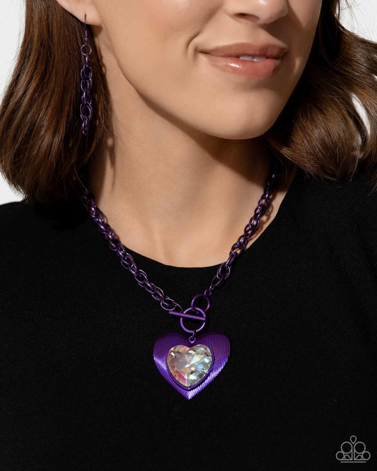 <p data-mce-fragment="1">Paparazzi Accessories - Modern Matchup - Purple Necklaces bordered in linear textures, an oversized white heart gem is pressed into an electric purple heart frame below the collar. The flirtatious pendant attaches to a thick, electric purple chain, resulting in a modern-inspired romance. Features a lariat closure.</p> <p data-mce-fragment="1"><i data-mce-fragment="1">Sold as one individual necklace. Includes one pair of matching earrings.</i></p>