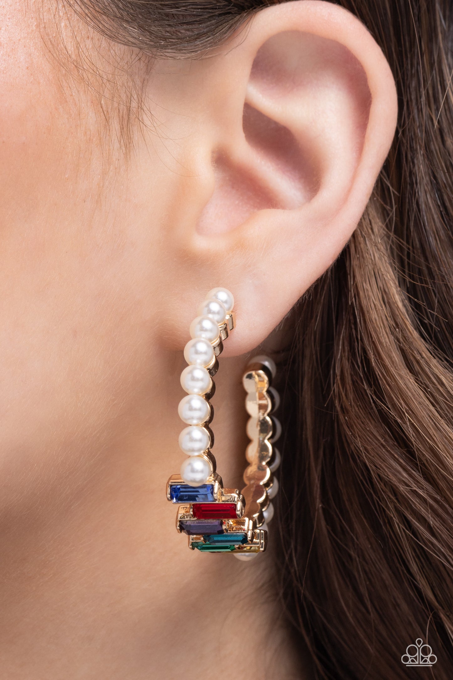 <p data-mce-fragment="1">Paparazzi Accessories - Modest Maven - Gold Earrings floating atop sleek gold fittings, a glamorous collection of classic white pearls, interrupted by a collection of staggered multicolored emerald-cut gems, delicately coalesces around a gold hoop for a sparkly statement. Earring attaches to a standard post fitting. Hoop measures approximately 1 3/4" in diameter.</p> <p data-mce-fragment="1"><i data-mce-fragment="1">Sold as one pair of hoop earrings.</i></p>