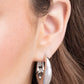 <p>Paparazzi Accessories - Oval Official - Silver Hoop Earrings featuring a thick surface, an elongated silver hoop curls around the ear for a sleek basic look. Earring attaches to a standard hinge closure fitting. Hoop measures approximately 3/4" in diameter.</p> <p><i>Sold as one pair of hinge hoop earrings.