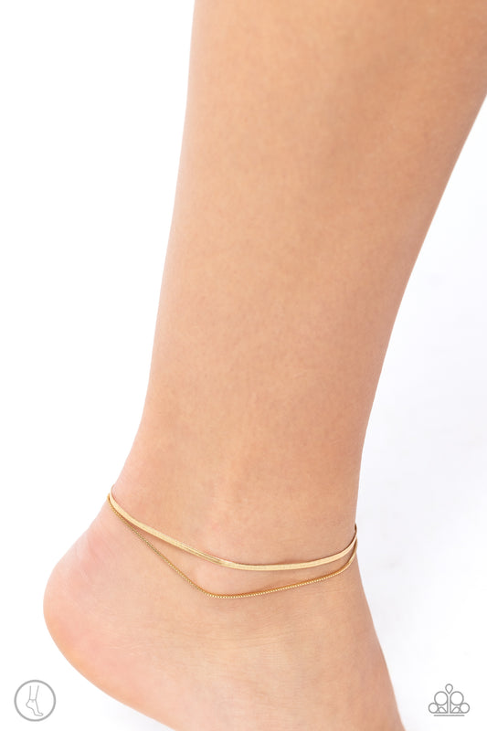<p>Paparazzi Accessories - Glistening Gauge - Gold Anklets a strand of flat gold snake chain collides with a dainty square box chain to create an abstract monochromatic display. Features an adjustable clasp closure.</p> <p><i>Sold as one individual anklet.</i></p>