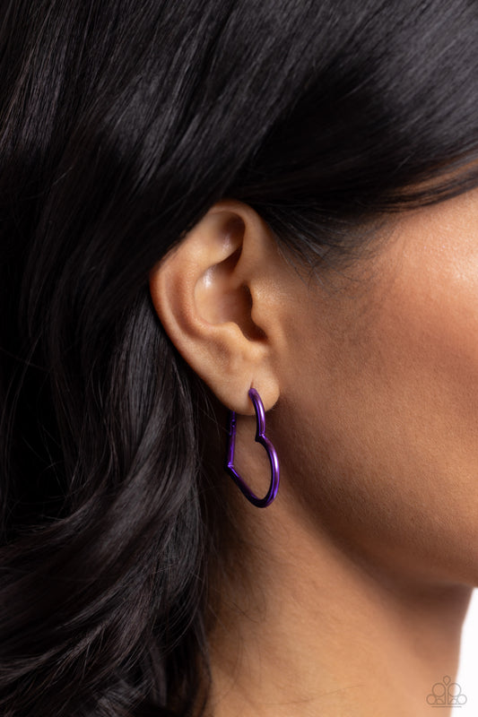 Paparazzi Accessories - Loving Legend - Purple Earrings f<span style="font-size: 1rem;">eaturing an electric purple hue, a heart silhouette hoop snugly curls around the ear for a colorfully romantic display. Earring attaches to a standard hinge closure fitting. Hoop measures approximately 1 1/2" in diameter. Sold as one pair of hinge hoop earrings.