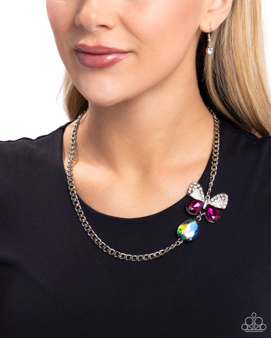 <p data-mce-fragment="1">Infused along a silver chain, an oversized butterfly flutters above a UV shimmery teardrop. The upper wings of the butterfly feature white rhinestones, while the bottom wings are formed from faceted magenta teardrops for a whimsical finish. Features an adjustable clasp closure. Due to its prismatic palette, color may vary.</p> <p data-mce-fragment="1"><i data-mce-fragment="1">Sold as one individual necklace. Includes one pair of matching earrings.</i></p>