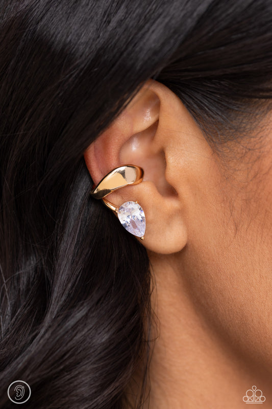 <p>Paparazzi Accessories - Twisting Teardrop - Gold Ear Cuffs fluttering atop a pronged gold fitting, a white gem teardrop shines from the ear. Features a smooth surface for sliding ability to desired position on the ear. Due to its structure, adjusting capability is limited.</p> <p><i>Sold as one pair of cuff earrings.</i></p>
