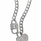 Embellished with glistening white rhinestones, a silver lock pendant and heart padlock interconnect from a silver curb chain for a romantic-inspired display of shimmer. Features an adjustable clasp closure.  Sold as one individual necklace. Includes one pair of matching earrings.