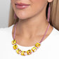 Linked along an electric pink chain, radiant-cut UV yellow gems are pronged in place along the neckline for a splash of dazzling color. Features an adjustable clasp closure.  Sold as one individual necklace. Includes one pair of matching earrings.