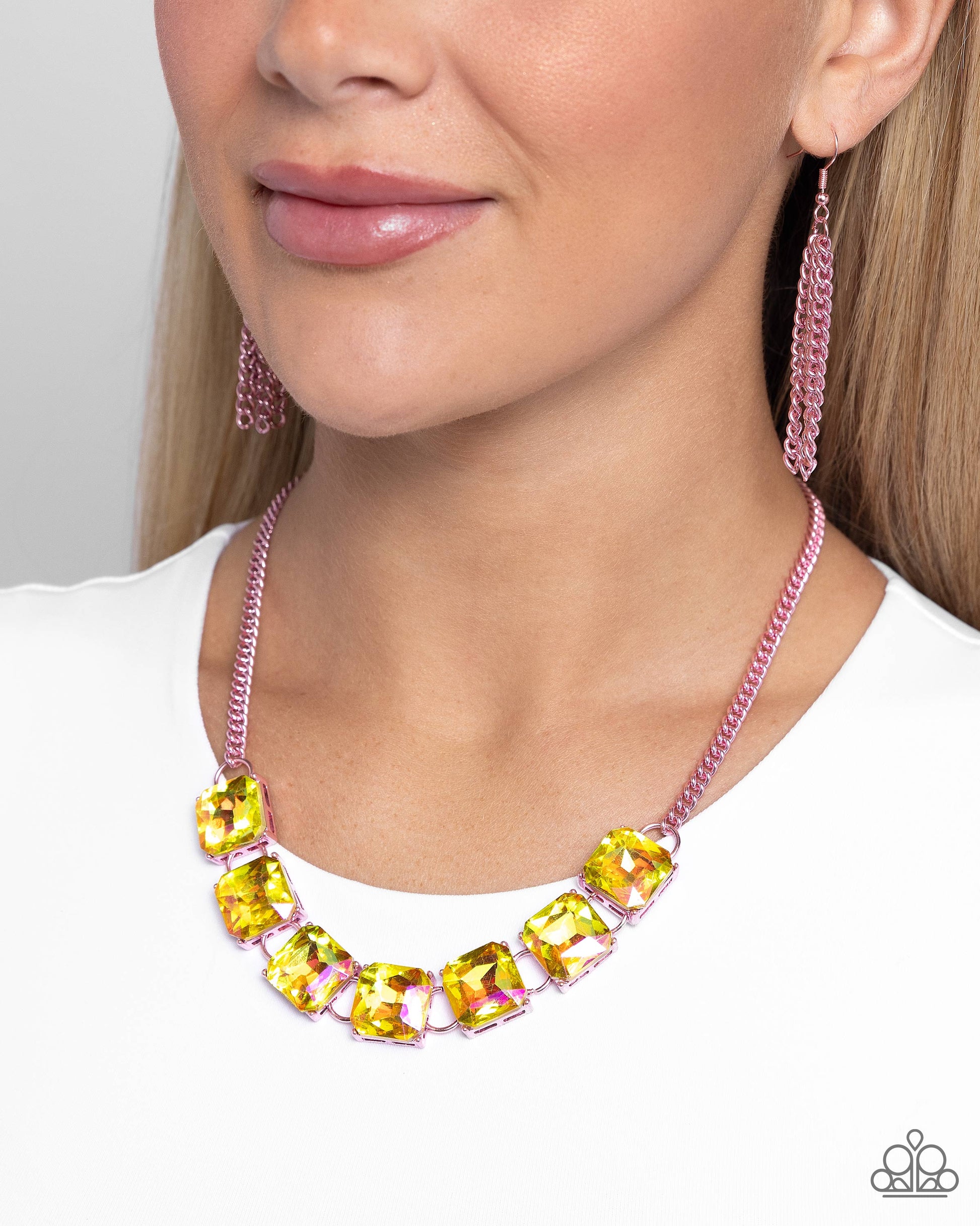 Linked along an electric pink chain, radiant-cut UV yellow gems are pronged in place along the neckline for a splash of dazzling color. Features an adjustable clasp closure.  Sold as one individual necklace. Includes one pair of matching earrings.