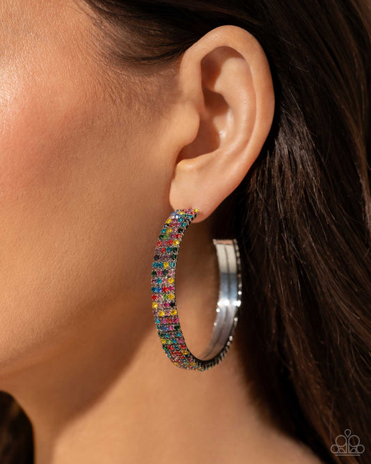 <p>Paparazzi Accessories - Stacked Symmetry - Multi Hoop Earrings set in silver square fittings, row after row of multicolored rhinestones are embellished around a silver hoop for a dazzling design. Earring attaches to a standard post fitting. Hoop measures approximately 2" in diameter.</p> <p><i>Sold as one pair of hoop earrings.</i></p>