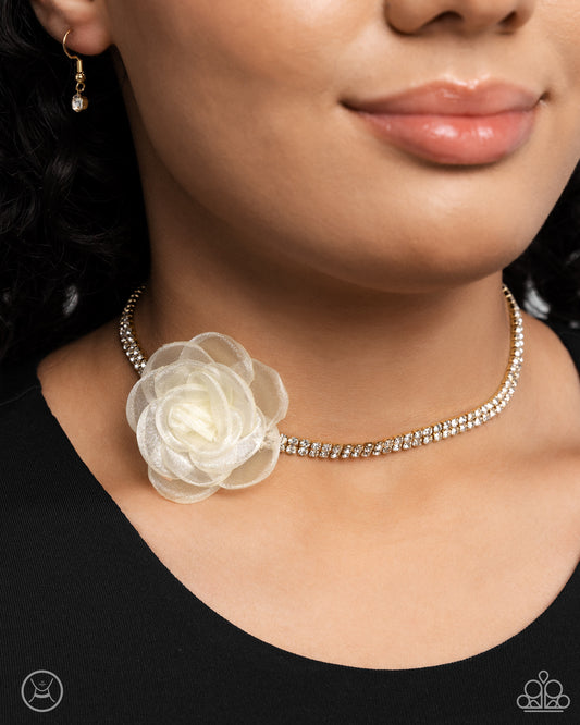 <p>Paparazzi Accessories - Rosy Range - Gold Necklaces a double-stranded gold chain is embellished with two rows of glistening white rhinestones as it wraps around the collar. An ivory tulle rosette is placed in the center of the design for a floral finish. Features an adjustable clasp closure.</p> <p><i>Sold as one individual choker necklace. Includes one pair of matching earrings.</i></p>