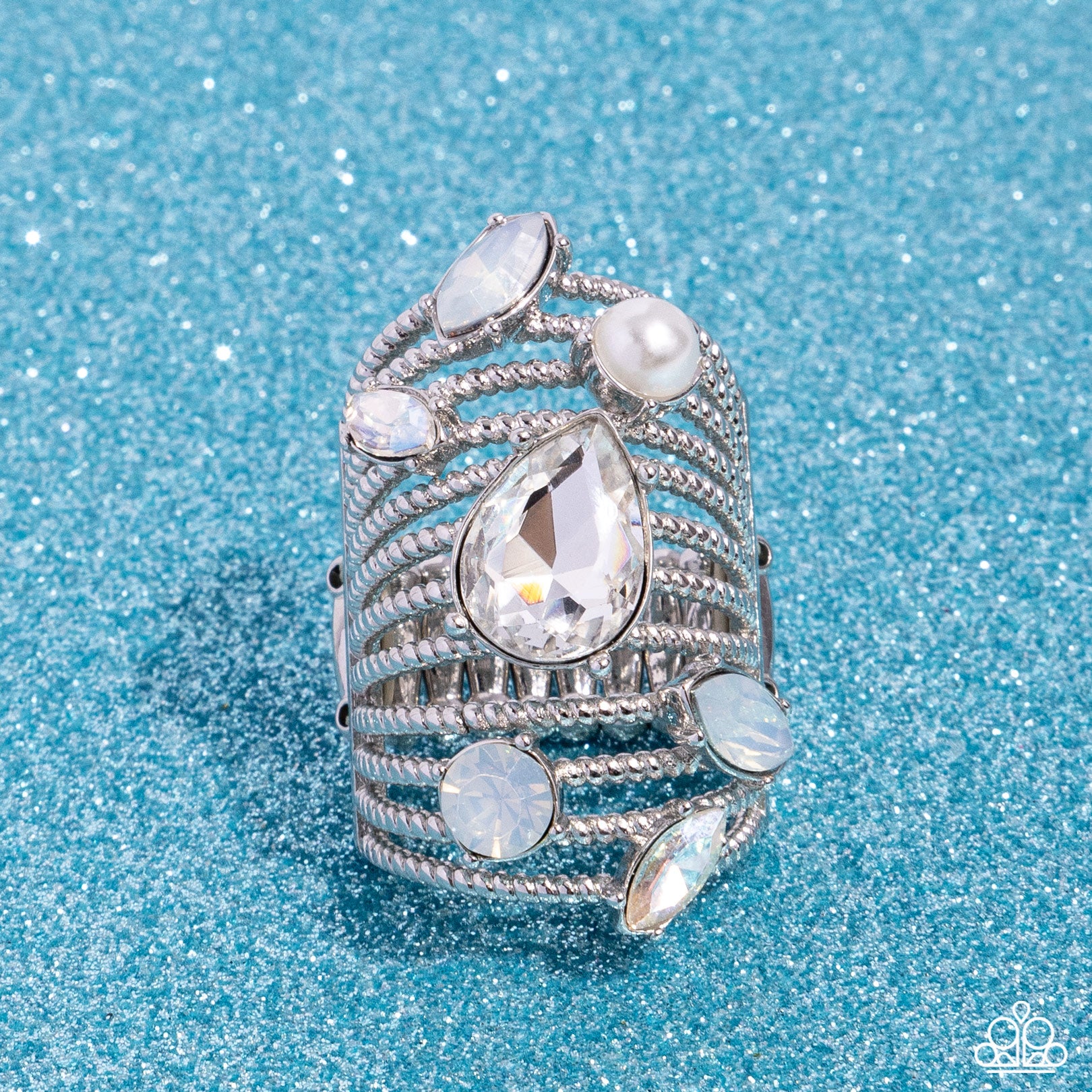 <p data-mce-fragment="1">Featuring a dazzling array of round, teardrop, and marquise-cut gems, pearls, and rhinestones in multicolored white hues, row after row of twisted silver bands stack up and across the finger for a knockout look. Features a stretchy band for a flexible fit.</p> <p data-mce-fragment="1"><i data-mce-fragment="1">Sold as one individual ring.</i></p>