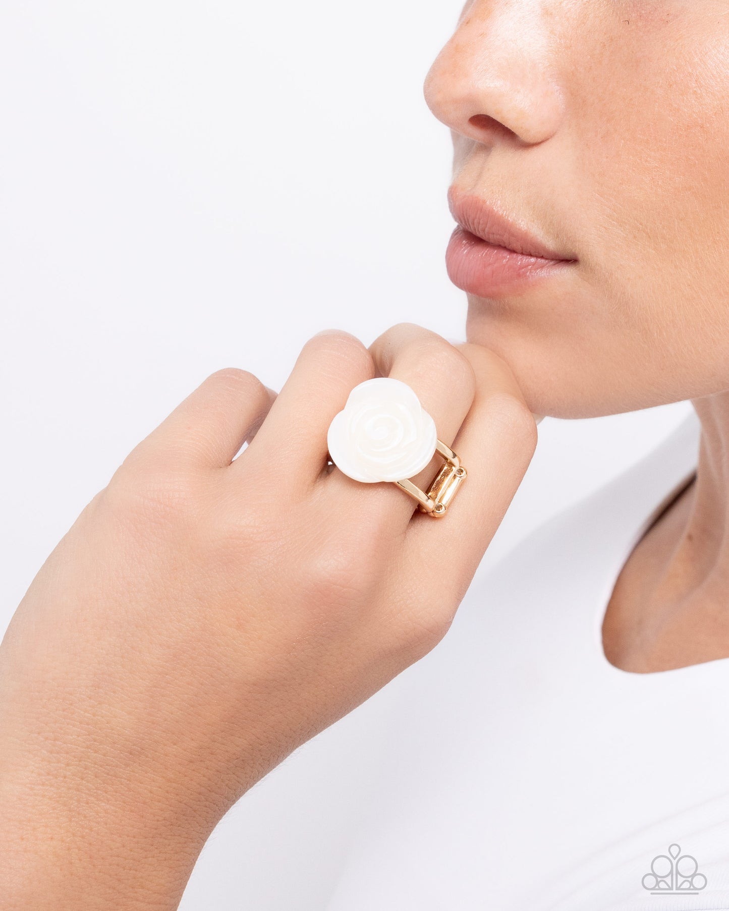 <p>Paparazzi Accessories - Top- SHELL Shine - Gold Rings featured in the center of an airy gold band, a white rosette is formed from shiny shell petals for a blooming basic atop the finger. Features a stretchy band for a flexible fit.</p> <p><i>Sold as one individual ring.</i></p>