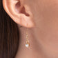 Set in pronged gold fittings, a faceted, glittery white gem glides along a gold snake chain for a beautiful basic. Features an adjustable clasp closure.  Sold as one individual necklace. Includes one pair of matching earrings.