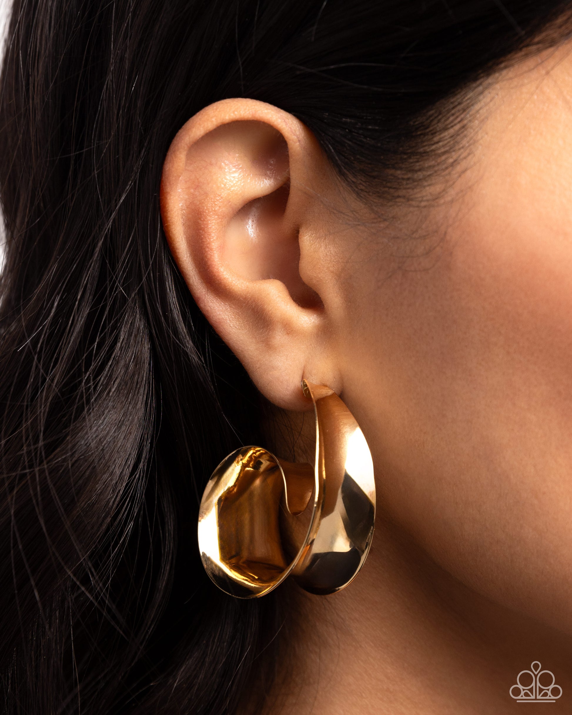 Featuring a sleek finish, a thick band of gold curls into a dainty swirl at the bottom of the ear for an eye-catching centerpiece. Earring attaches to a standard post fitting. Hoop measures approximately 1 1/2" in diameter.  Sold as one pair of hoop earrings.