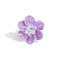 Featuring a warped shell-like texture, an oversized lavender flower glimmers atop the finger for a whimsical finish. Dainty silver studs and clear crystal beads coalesce the center of the flower, adding additional tactile detail. Features a stretchy band for a flexible fit.  Sold as one individual ring.