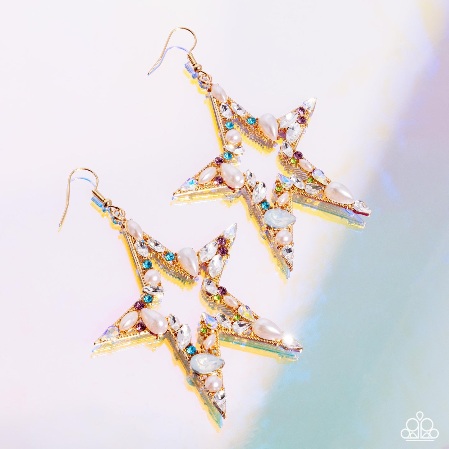 Multicolored rhinestones and gems in various cuts adorn the front of an oversized gold star silhouette, creating a stellar, sparkling centerpiece. Glossy white pearls also in various cuts are sprinkled along the variegated display of shimmer for additional refinement. Earring attaches to a standard fishhook fitting.  Sold as one pair of earrings.