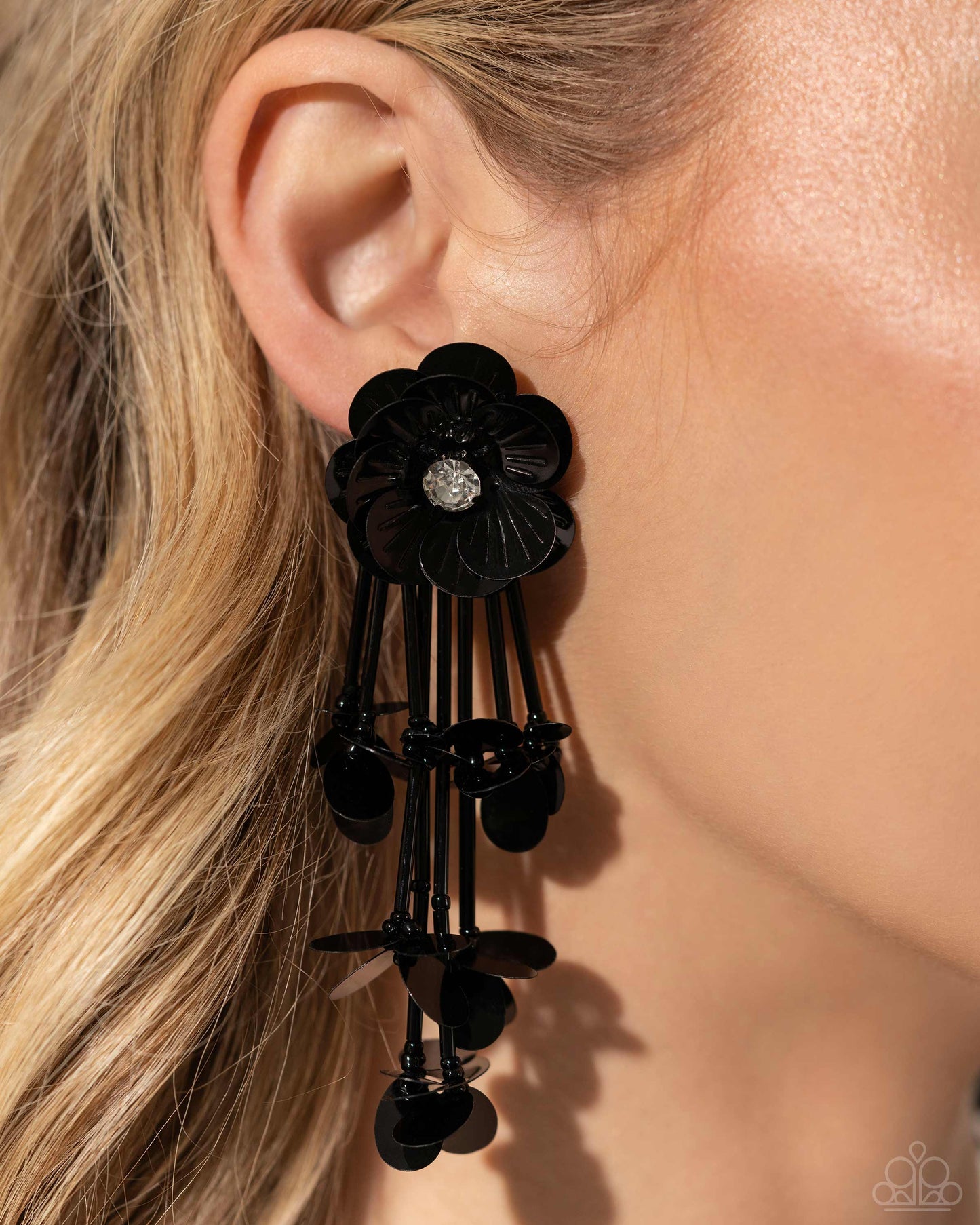<p data-mce-fragment="1">Blooming from a faceted white gem center, textured black sequin petals give way to a collection of black cylindrical beaded strands that elongate the neck. Sporadically bursting amongst the strands, a collection of simple black sequins flicker and flash for additional eye-catching interest. Earring attaches to a standard post fitting.</p> <p data-mce-fragment="1"><i data-mce-fragment="1">Sold as one pair of post earrings.</i></p>